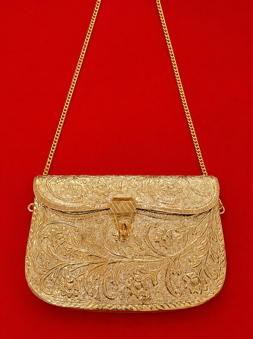 Gold embroidered handbag with a chain strap on a red background