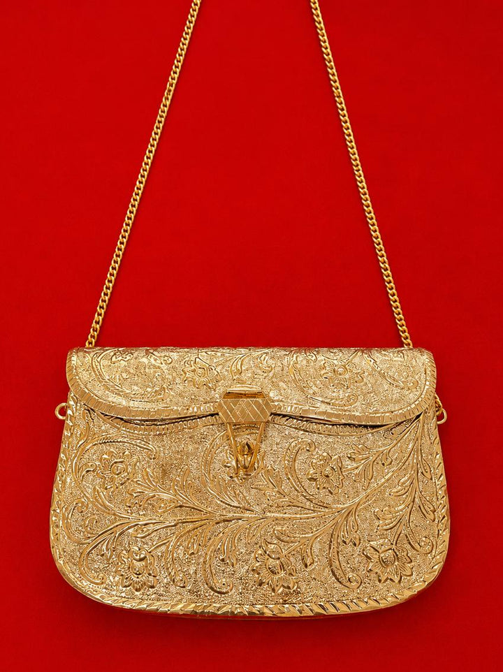 Gold embroidered handbag with a chain strap on a red background